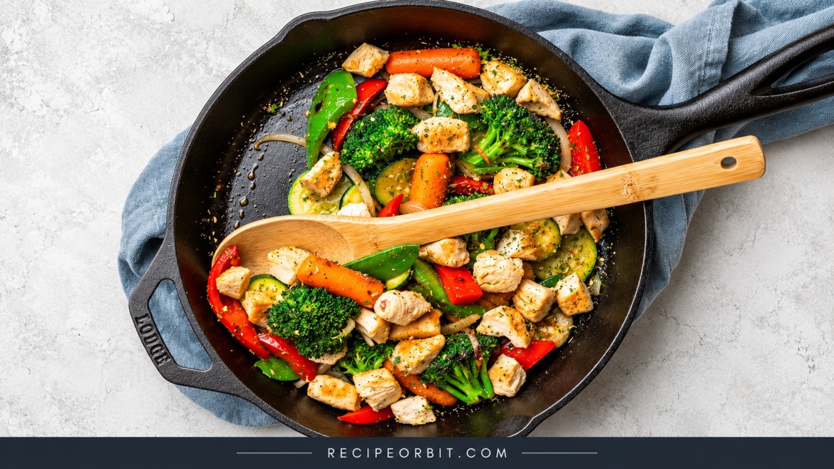 Skillet chicken and vegetable stir-fry with broccoli, carrots, bell peppers, and zucchini.